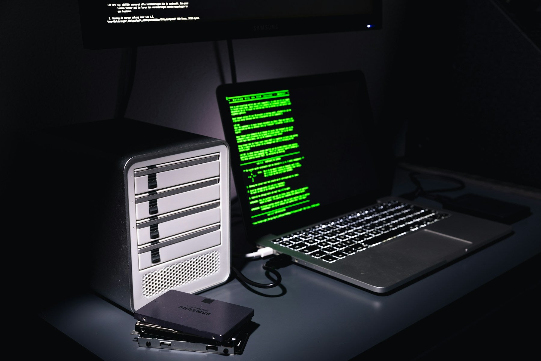 Laptop connected to an external storage enclosure; illustrative hardware photo.