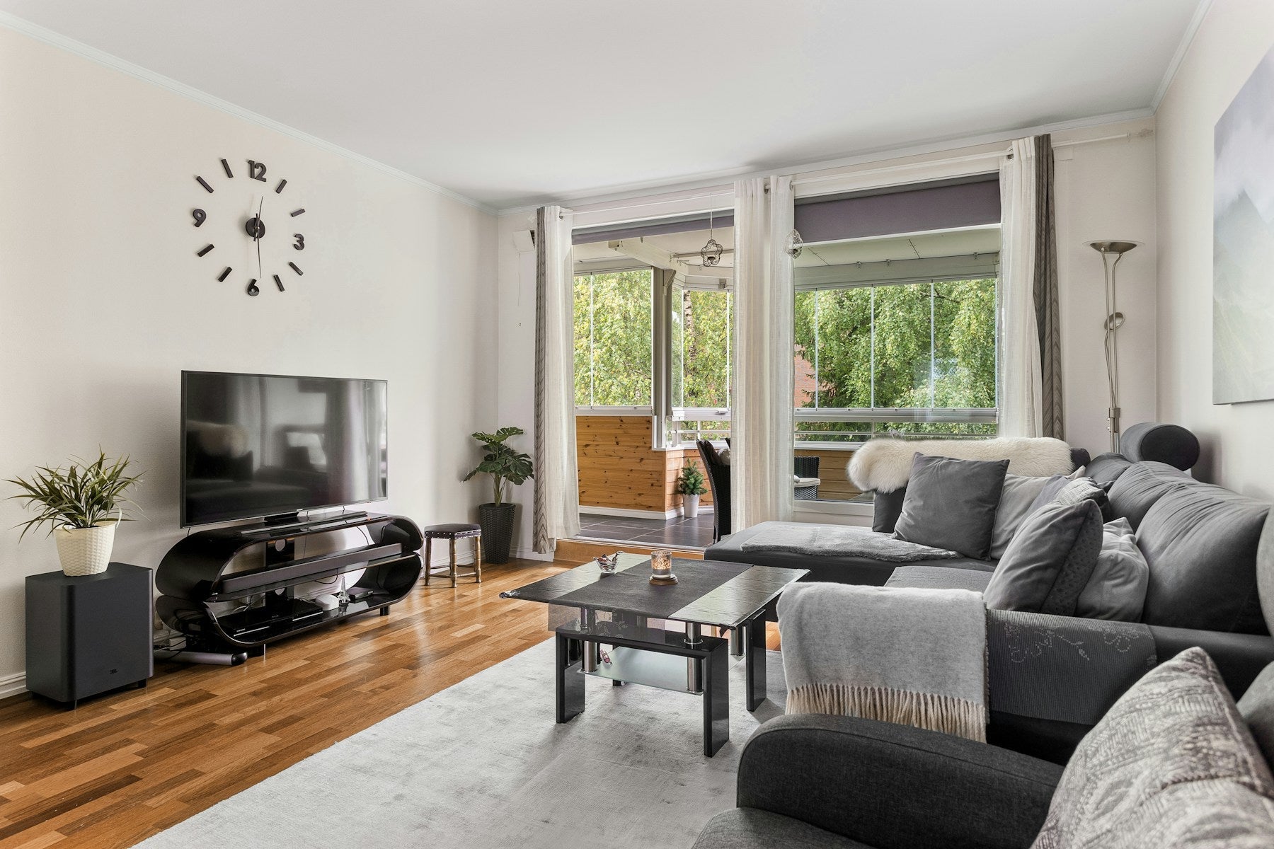 A television and comfortable seating arranged in a bright living room